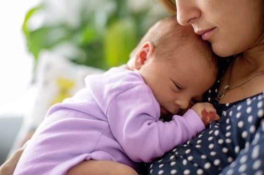 infant with hemangioma held by mother